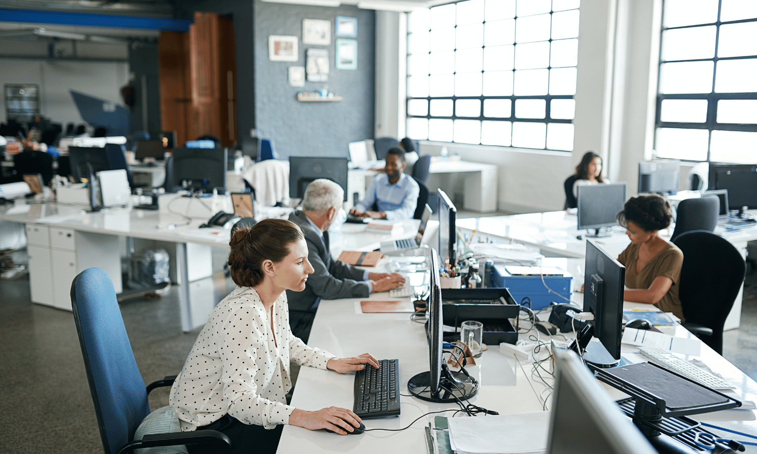 Contact centre operatives using Mailock secure email on desktop computers in corporate office