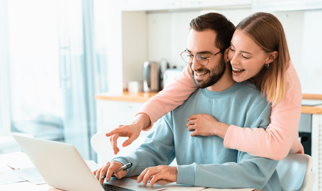 Couple reviewing annual returns together on a laptop, representing secure sharing of sensitive financial information with Mailock