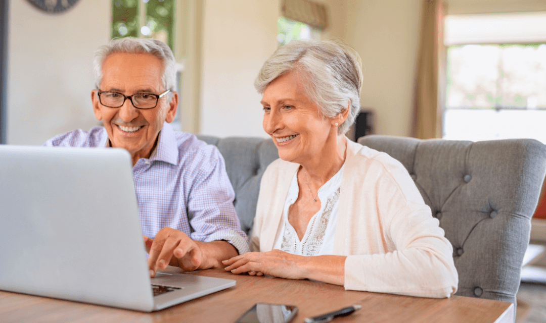 Couple reviewing financial information for annual returns on a laptop, representing secure sharing of sensitive personal data with Mailock