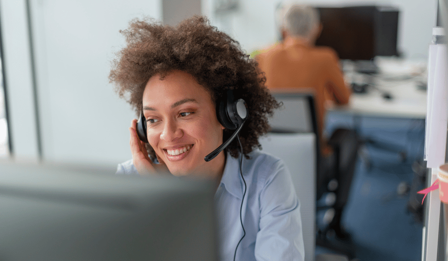 Customer service agent using headset at computer, representing secure customer communications and protected email handling with Mailock
