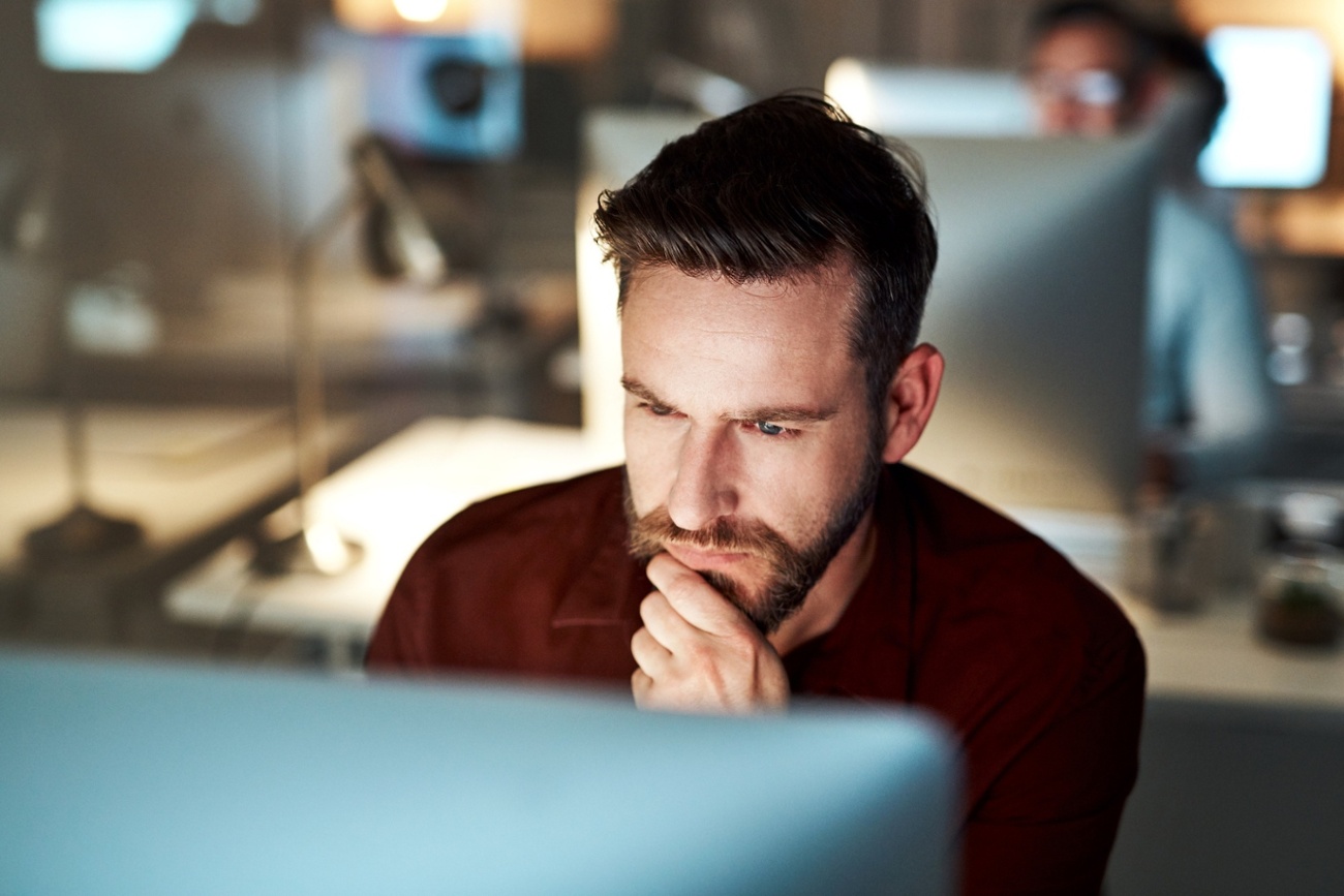Professional reviewing sensitive information on screen, representing secure email use and protected communication with Mailock