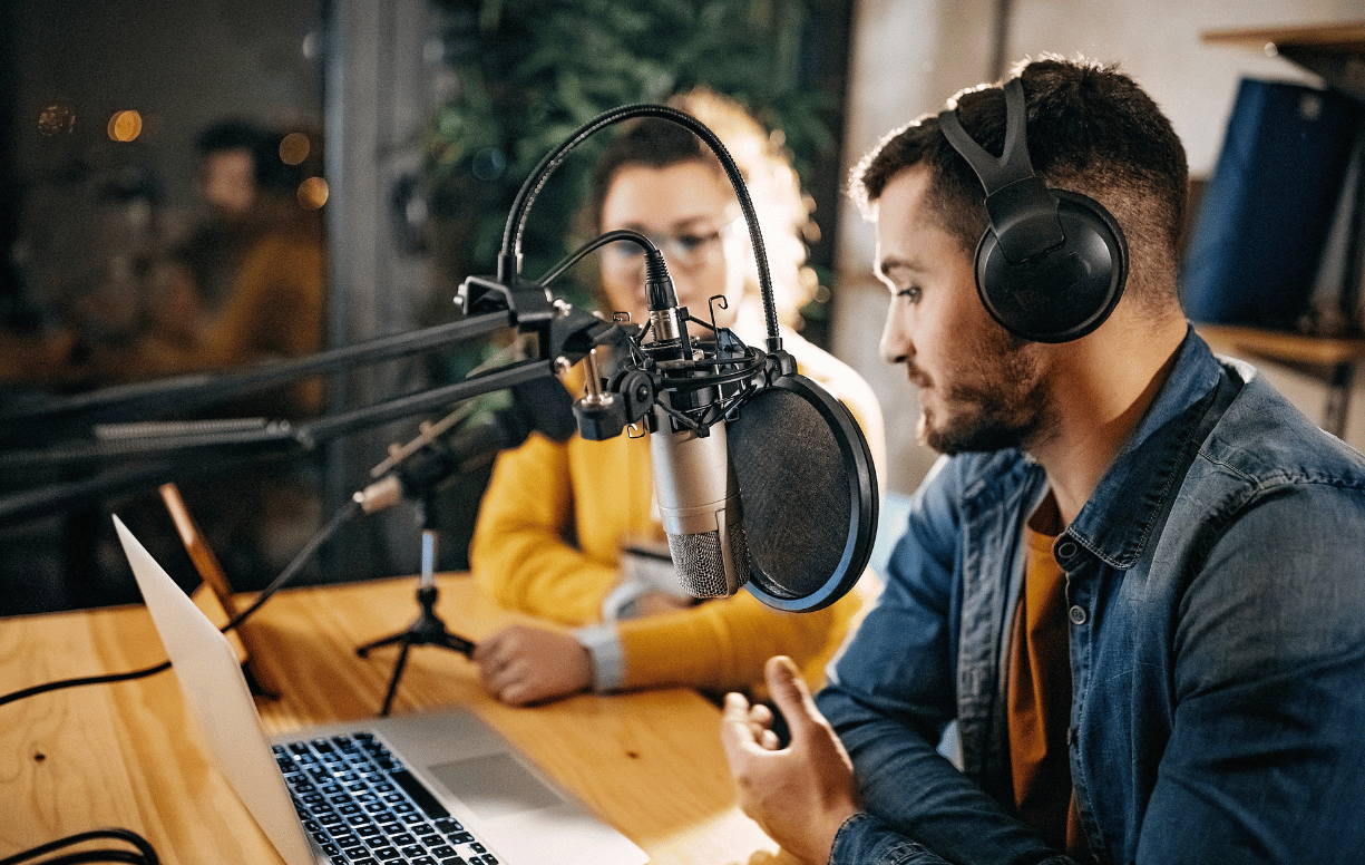 Professional recording a conversation on a laptop with microphone and headset, representing secure communication and protected information sharing with Mailock
