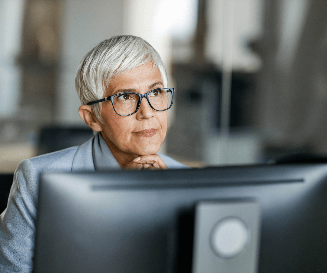 Female financial adviser using computer in office to communicate securely with clients