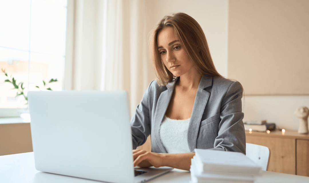 Professional preparing annual returns on a laptop, representing secure handling and submission of sensitive financial information with Mailock