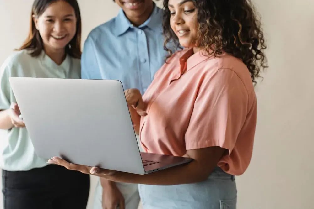 Colleagues reviewing software together on a laptop