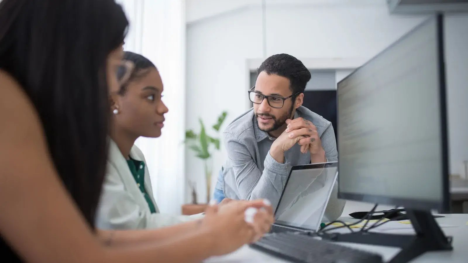 Business colleagues comparing secure email options on a computer