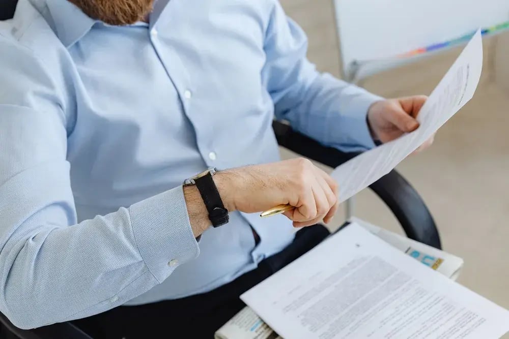 A professional reviewing compliance documents