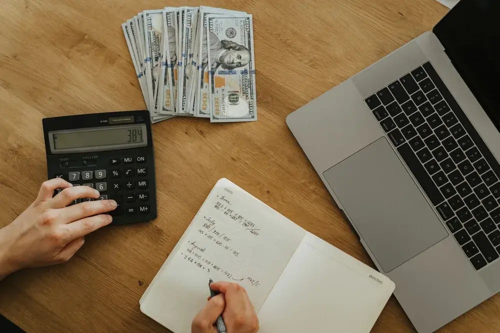 A calculator and notes for working out cost savings