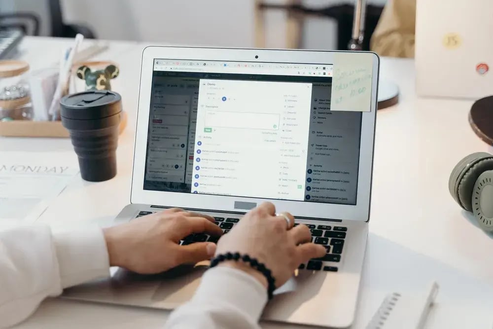 A professional sending email on a laptop