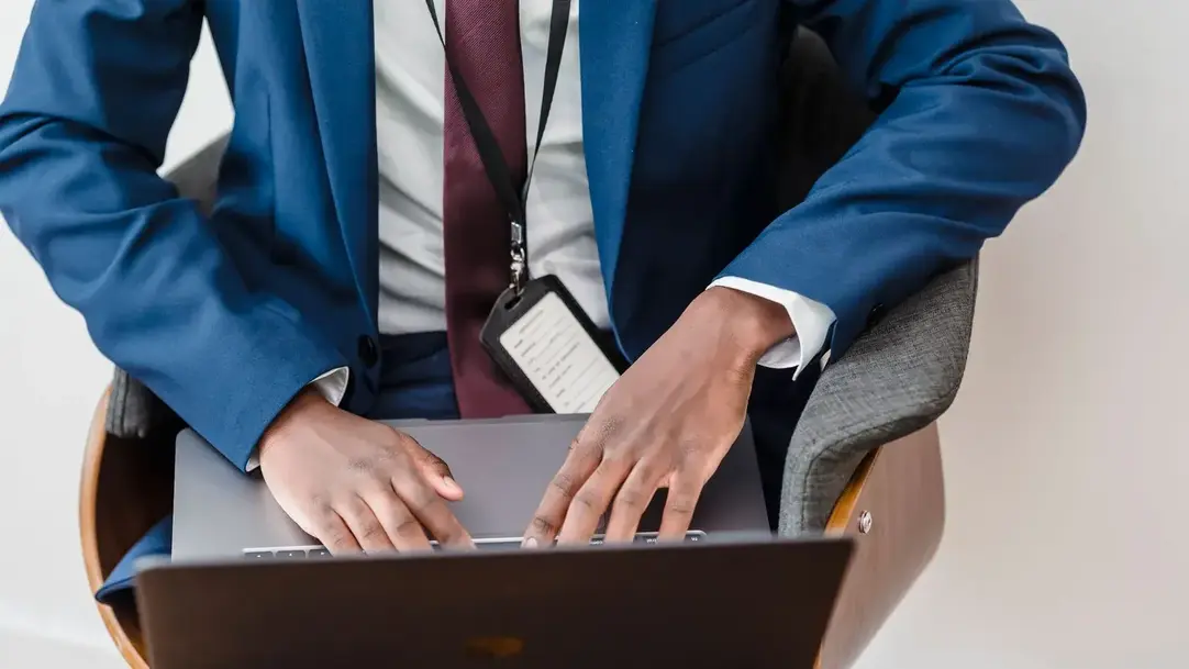 A professional verifying identity on a laptop