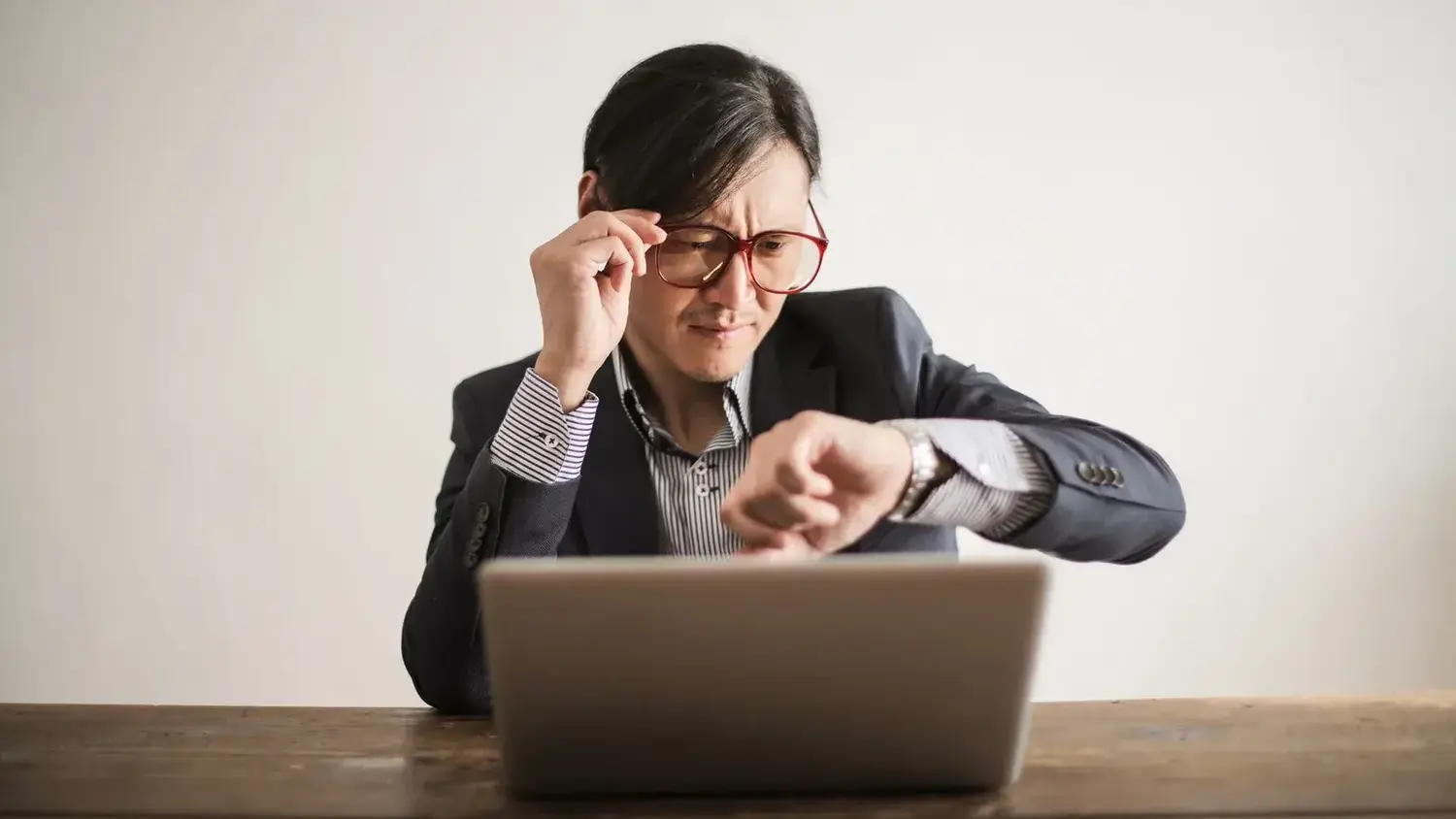 A professional looking concerned at a laptop