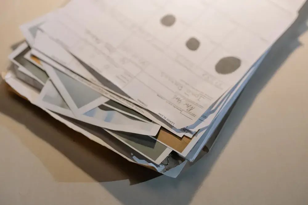 A stack of paper documents on a desk
