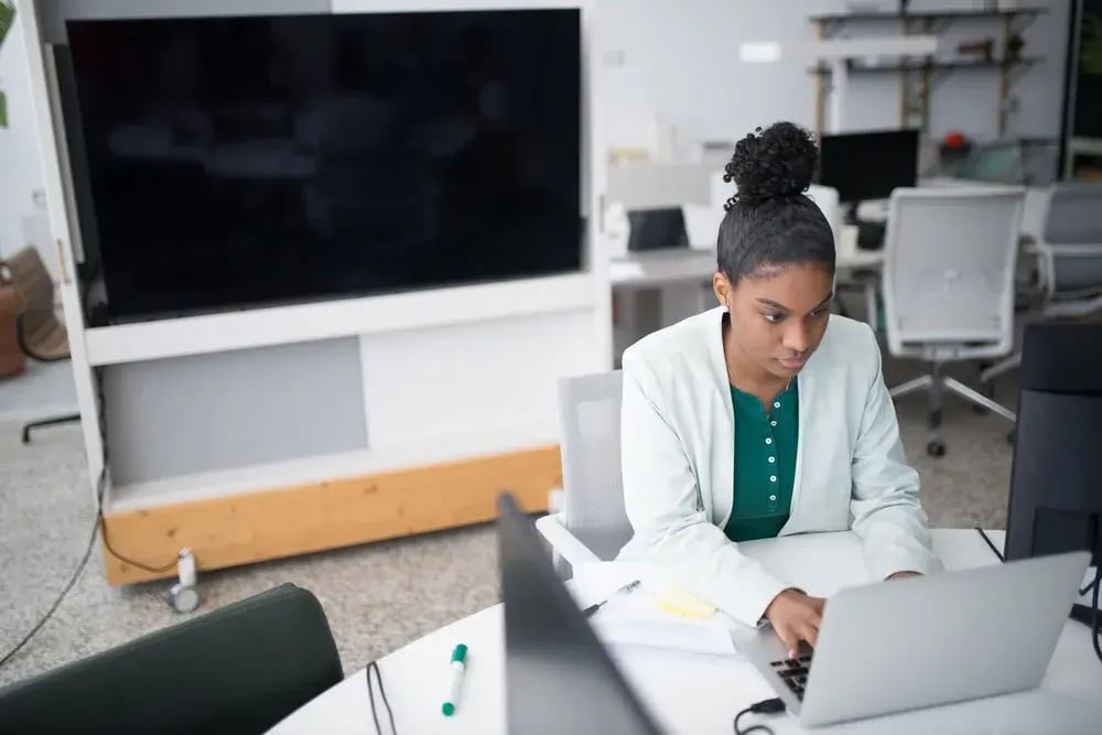 Professional working on a laptop in an office