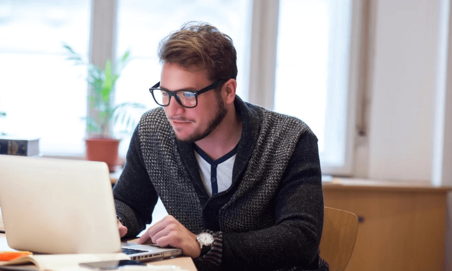 man in his home office using laptop for secure email