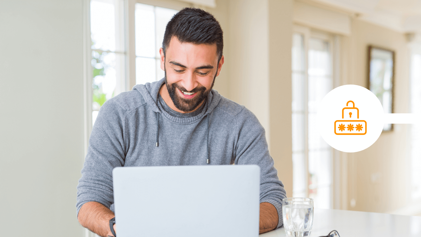 A man smiles while using a laptop at home, beside an orange padlock and password icon representing email encryption