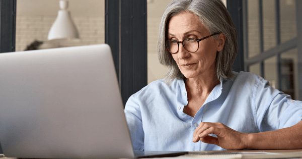Woman in office reading secure email on desktop