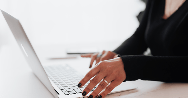 Professional typing on laptop to send email securely